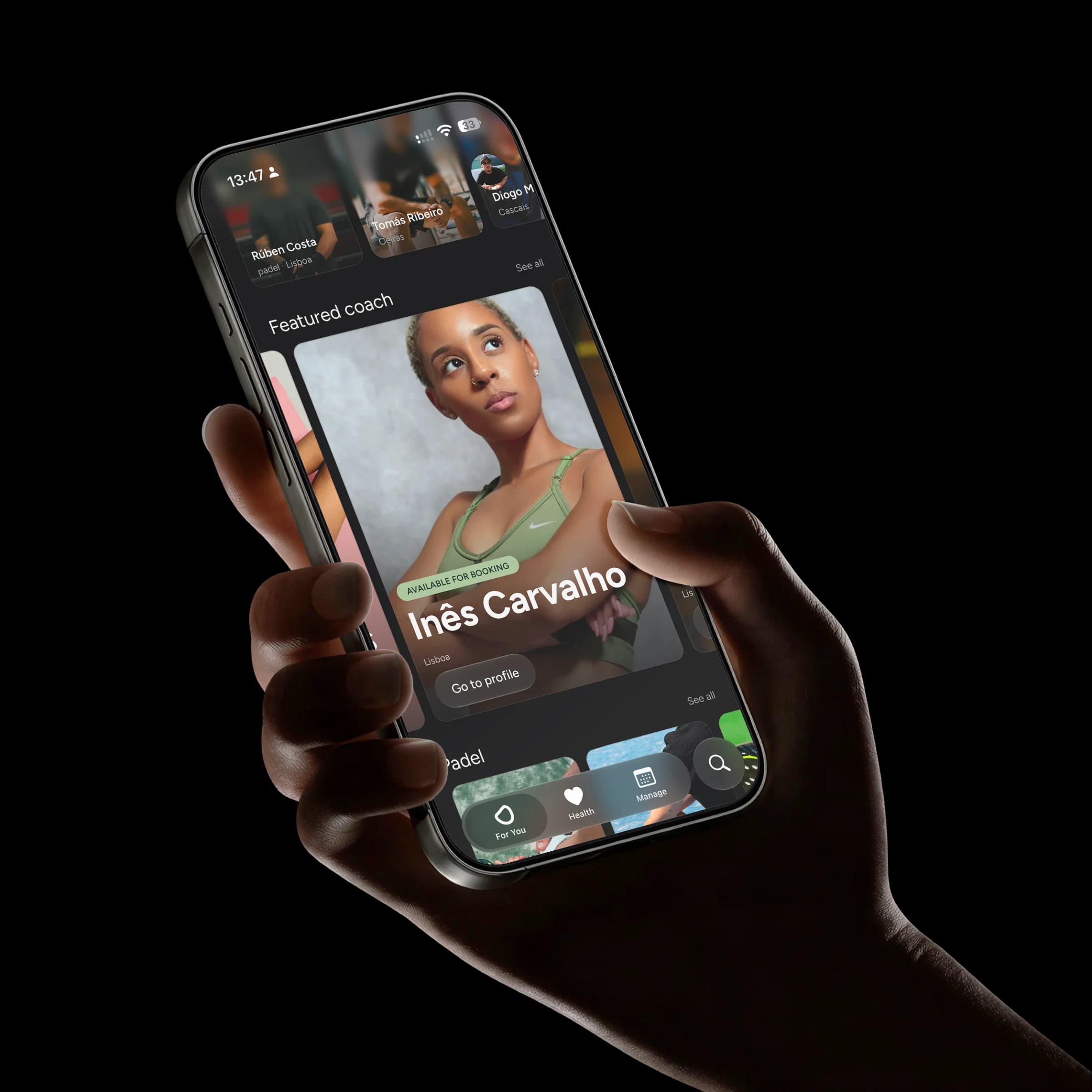 The GTRND app held in a hand, showing a featured coach